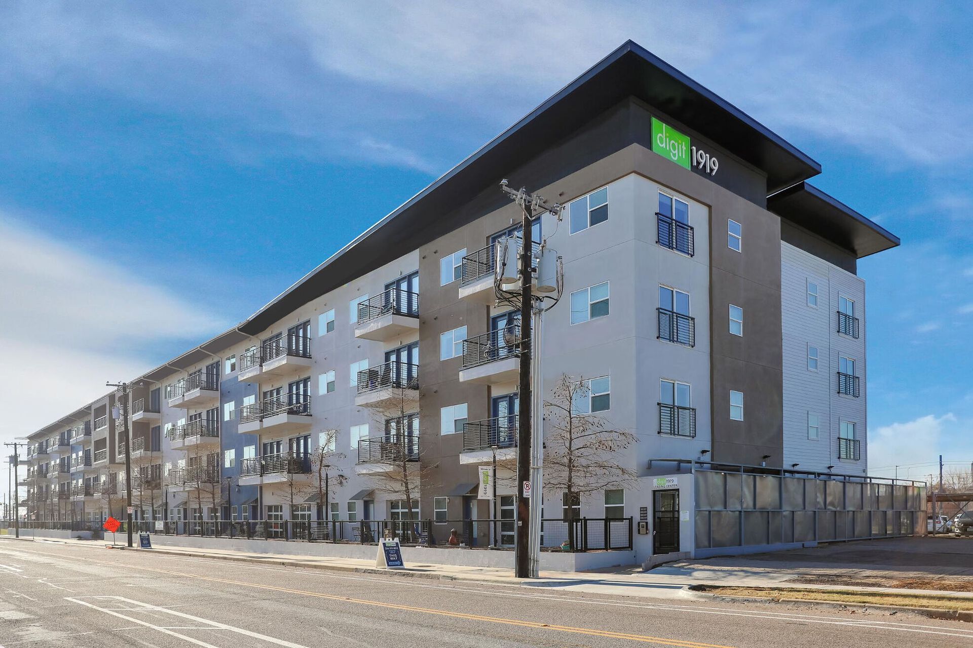 Exterior view of an apartment building featuring balconies and modern architecture.
