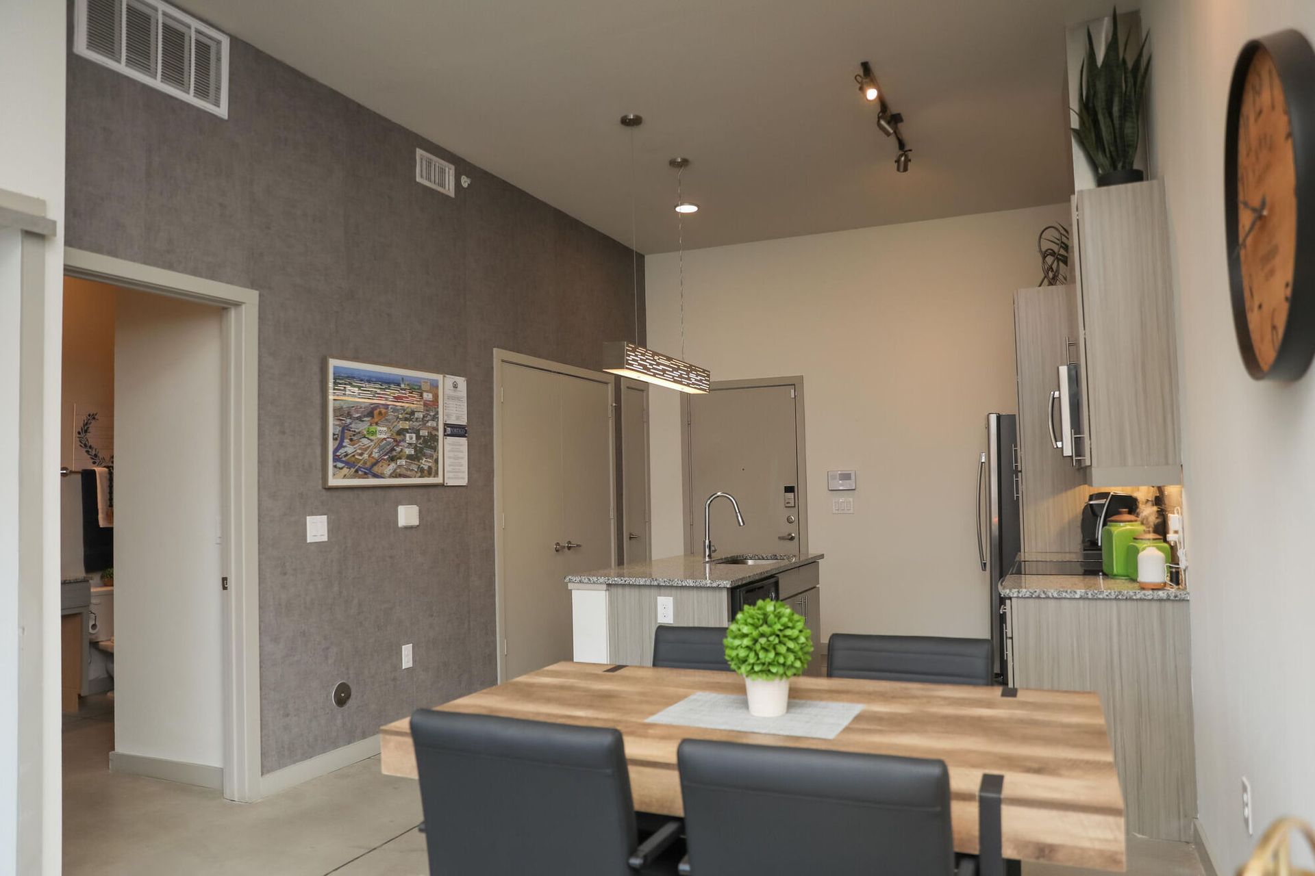 Modern apartment interior featuring a dining table and kitchen