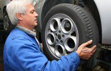 Man repairing auto wheels