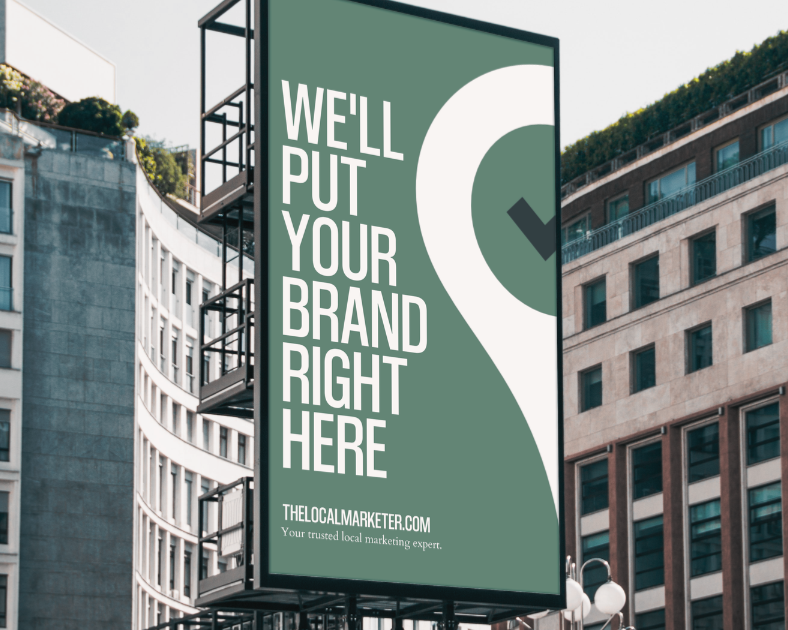 Person typing on a laptop with a map and graph displayed, coffee and a book on a wooden desk.