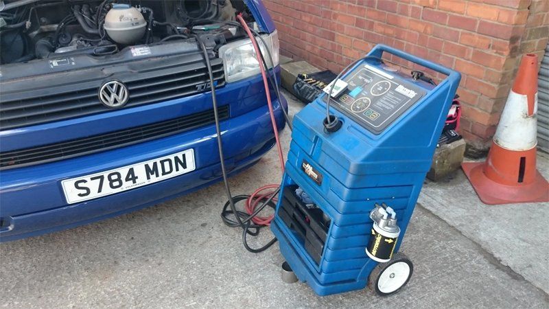 Close up of engine diagnostic machine and blue car