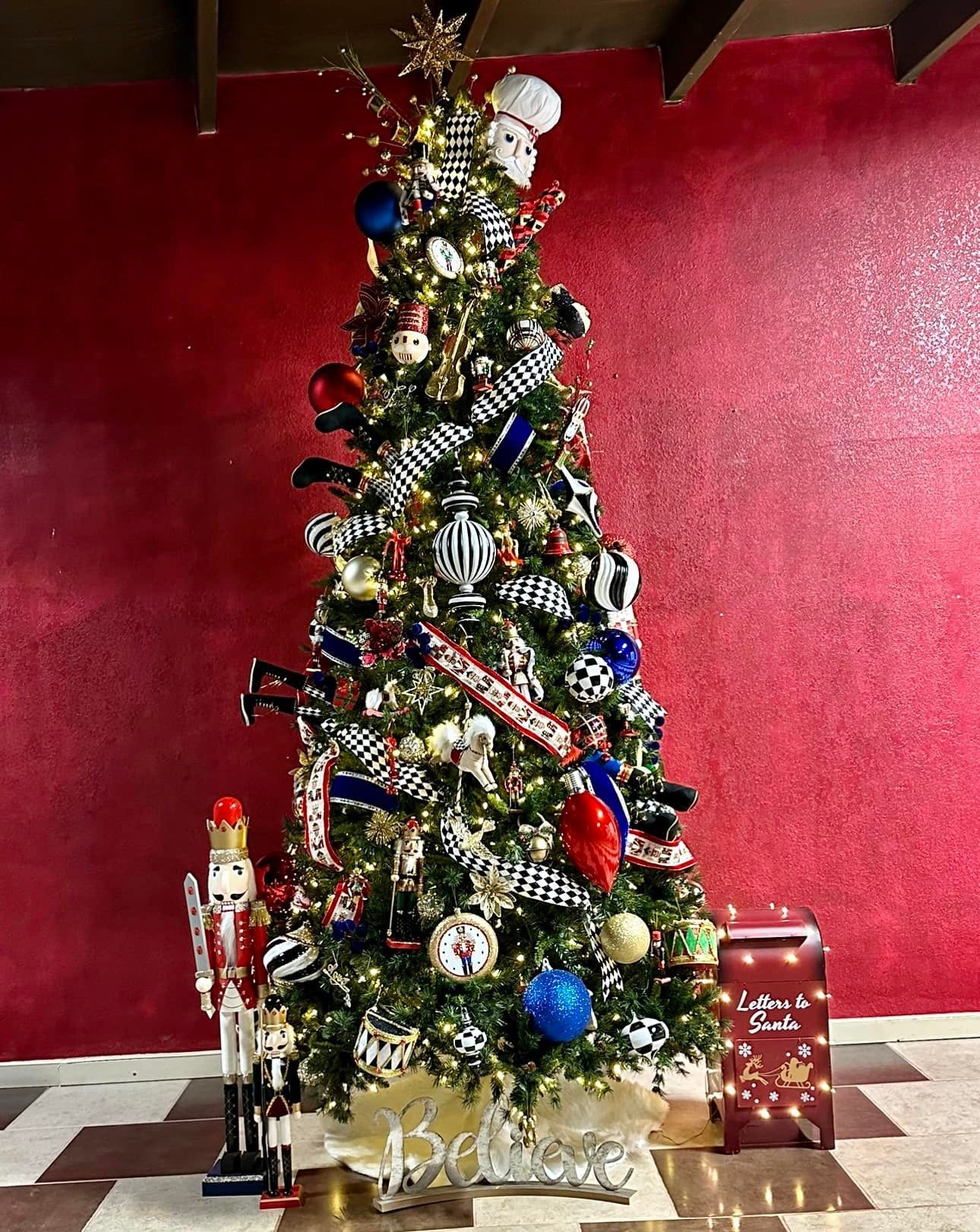A christmas tree with a nutcracker in front of it