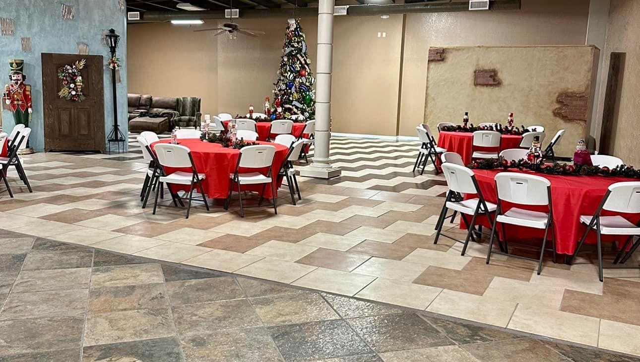 A large room with tables and chairs set up for a christmas party.