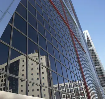 A building with a lot of windows and a blue sky in the background