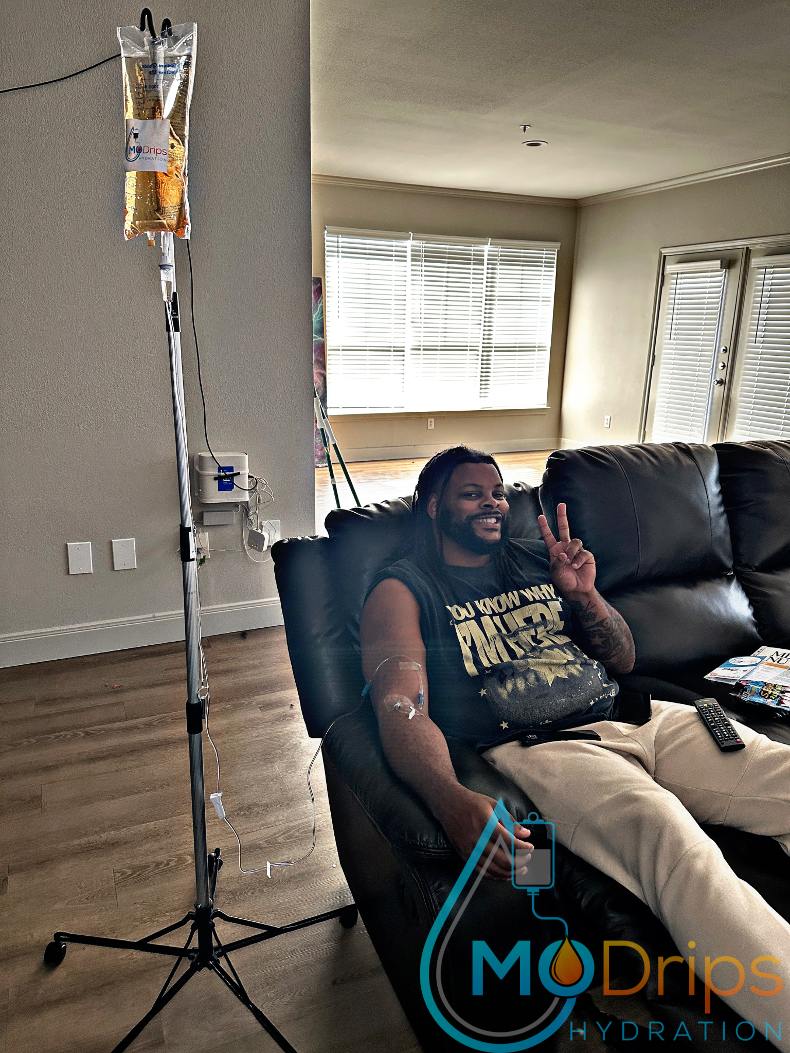 A man is sitting in a chair with a drip on his arm