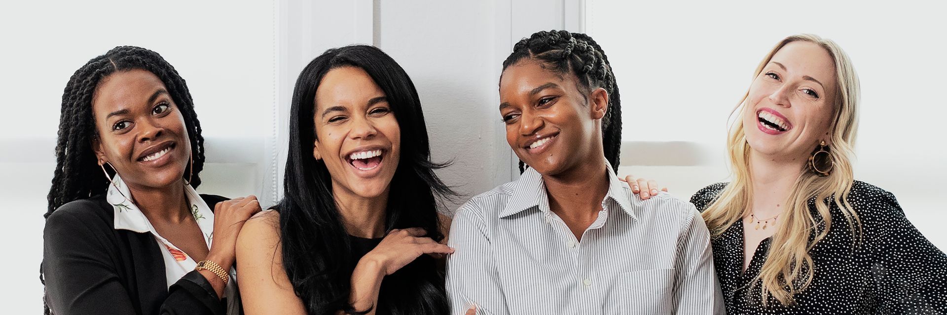 A group of women are standing next to each other and smiling.