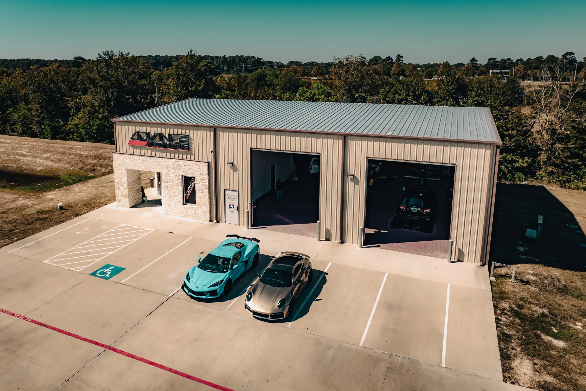 Exterior view of a car garage with two parked sports cars. | Advance Automotive