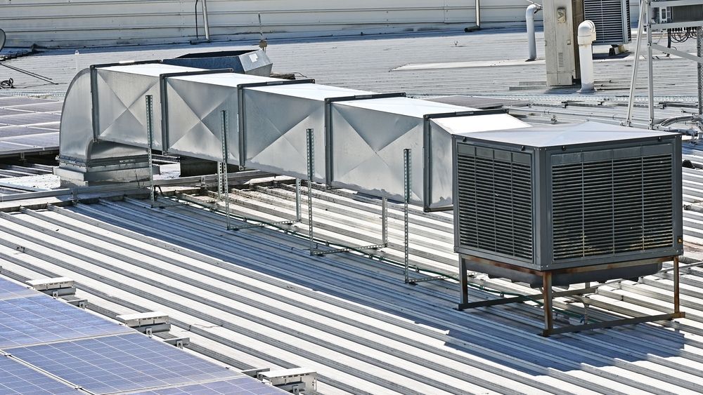 A Rooftop With a Row of Metal Ducts Going Up It — FVS Airconditioning & Electrical Pty Ltd in Julia Creek, QLD