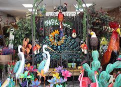 Colorful Easter display with large bird and flower decorations in a store entrance