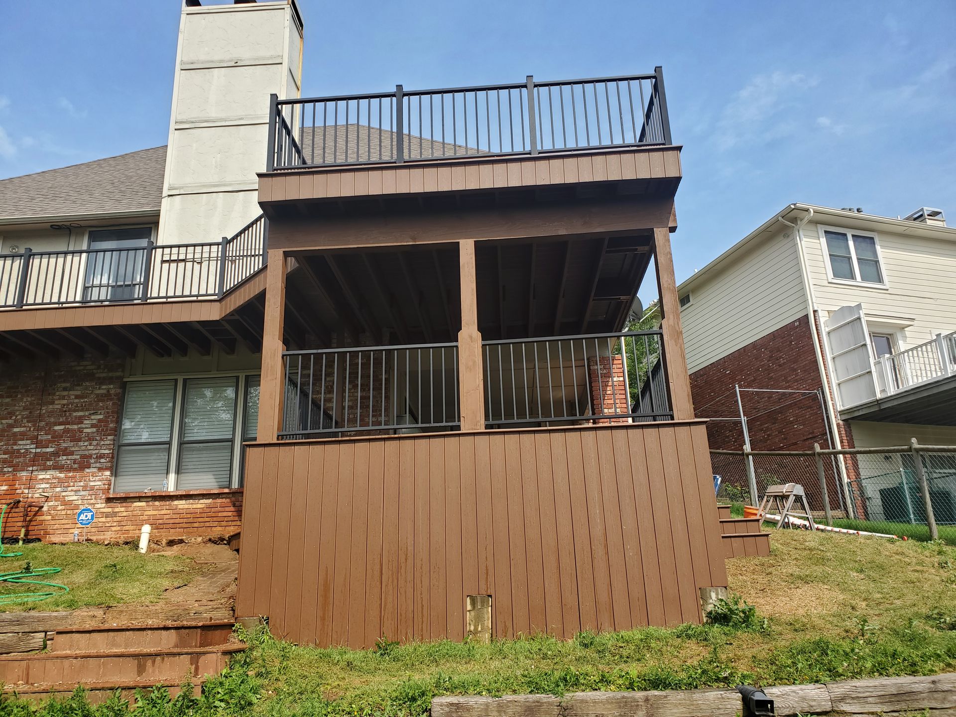 A house with a large deck on top of it.