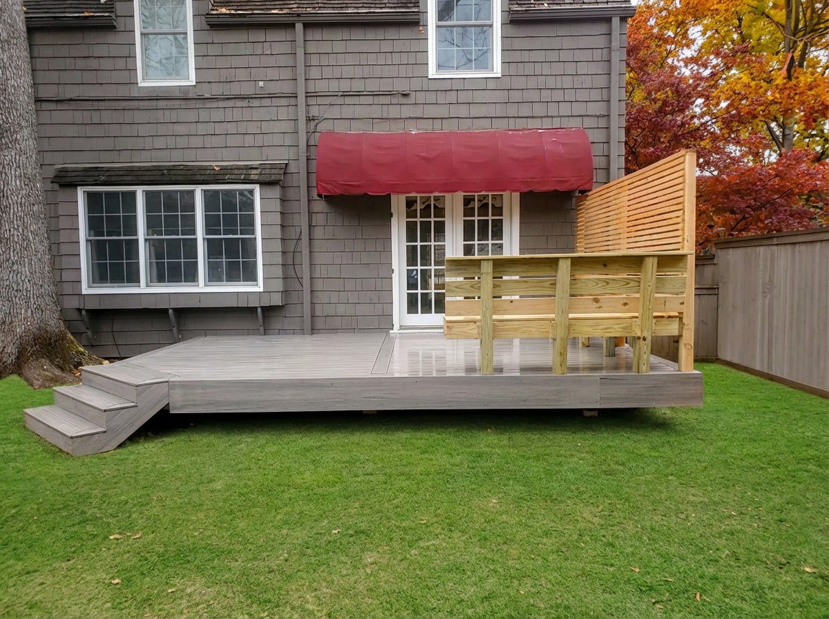A man is working on a deck in front of a house.