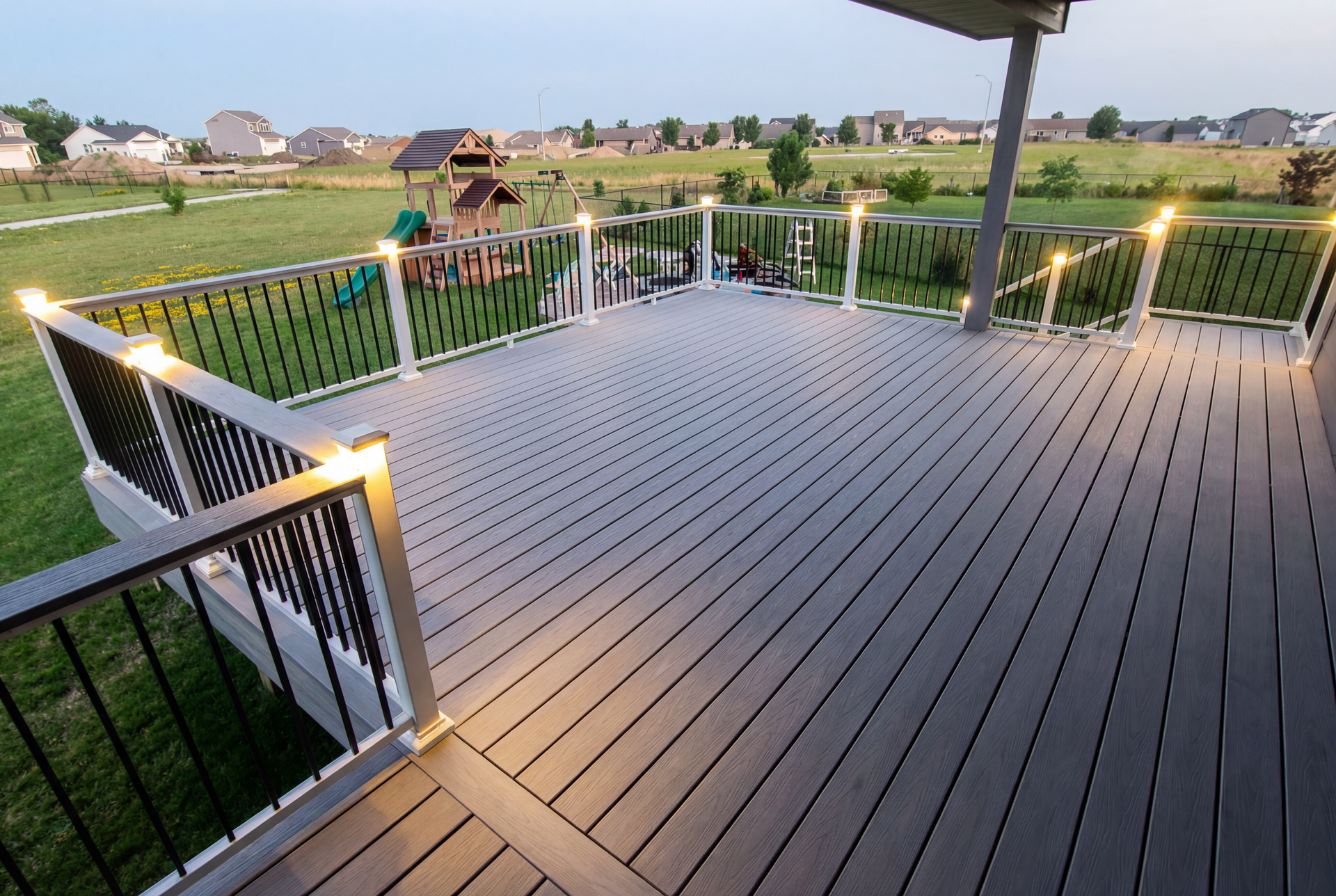 A large deck with lights on it and a view of a field.