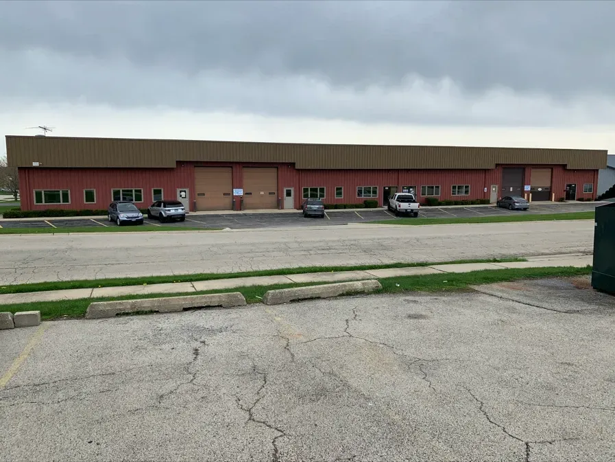 A large building with a lot of cars parked in front of it