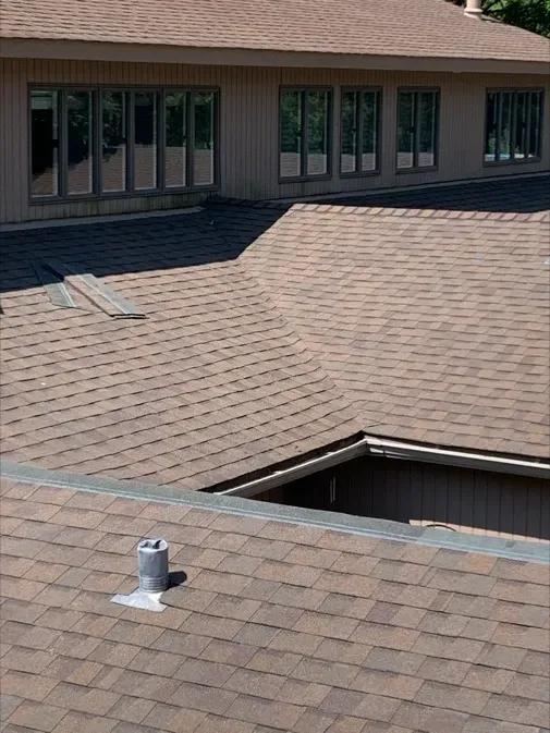 The roof of a house has a skylight on it