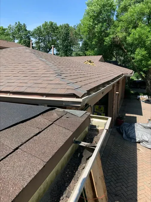 A house with a gutter on the side of it.