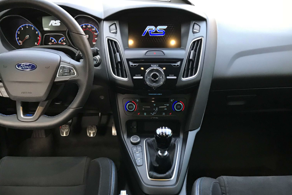 The interior of a ford focus rs with a steering wheel and dashboard.