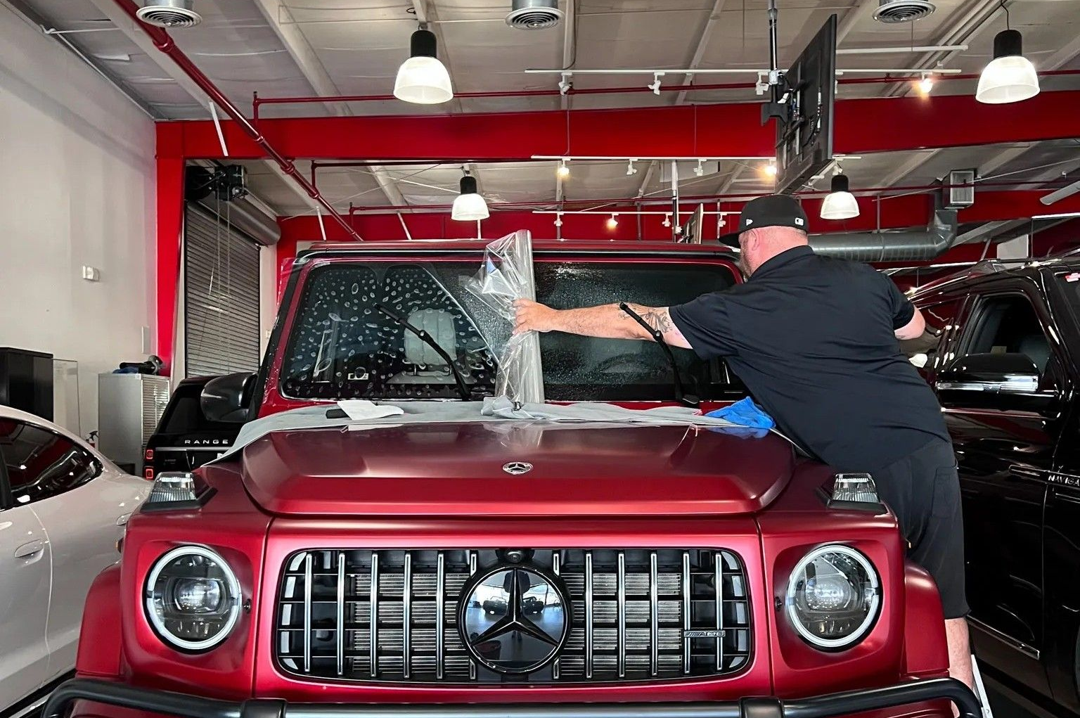 A blue truck with a canopy is parked in a garage.