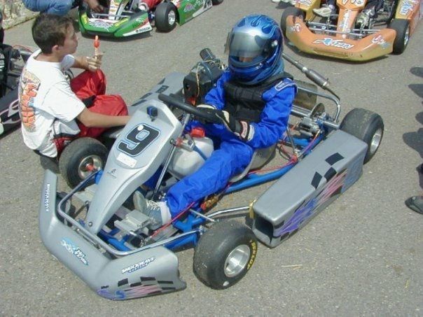 A person in a go kart with the number 13 on it