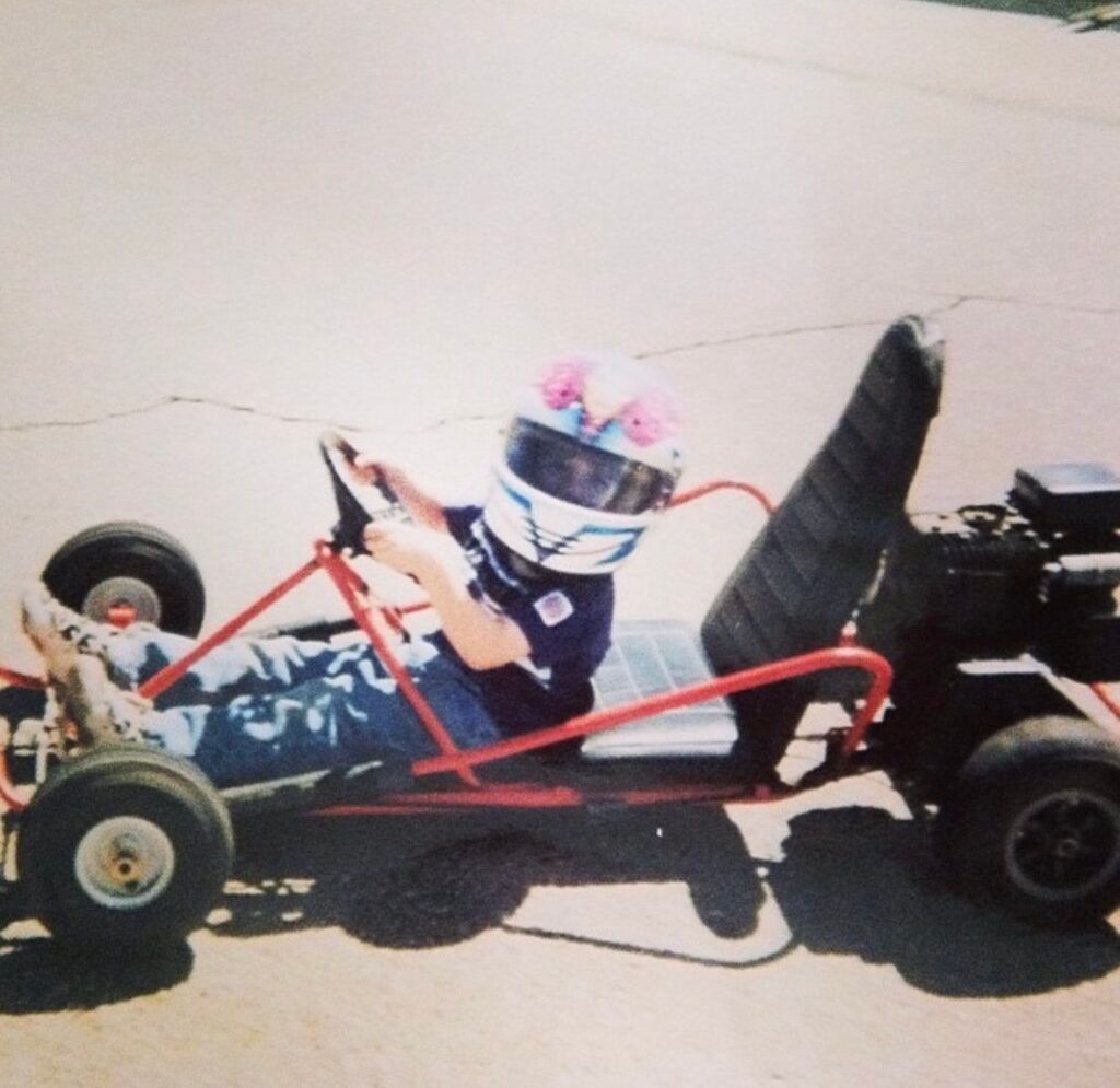 A person wearing a helmet is driving a go kart