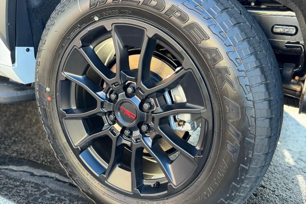 A close up of a tire and wheel on a truck.