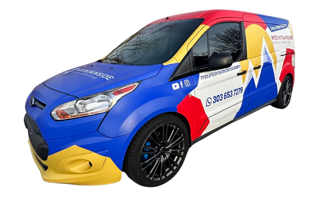 A blue , red , and yellow van is sitting on a white background.