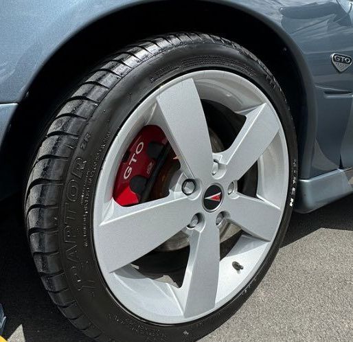 A close up of a car wheel with the word gto on it