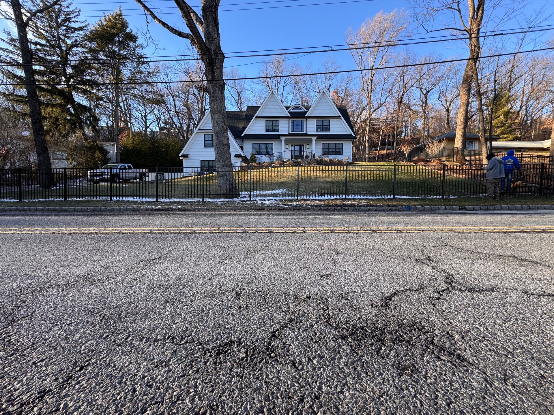 A close up of a wire fence with trees in the background.
