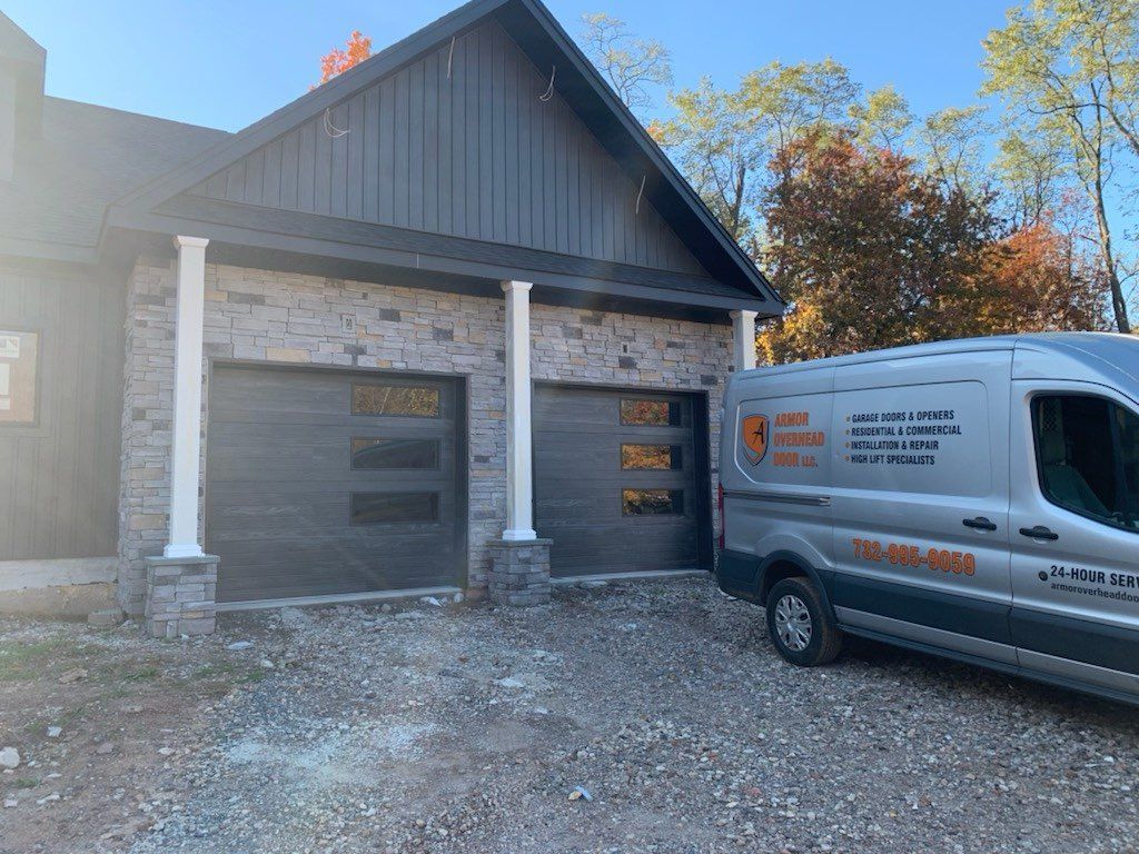 A van is parked in front of a garage door.