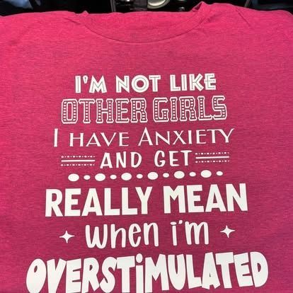 Pink t-shirt with white text: