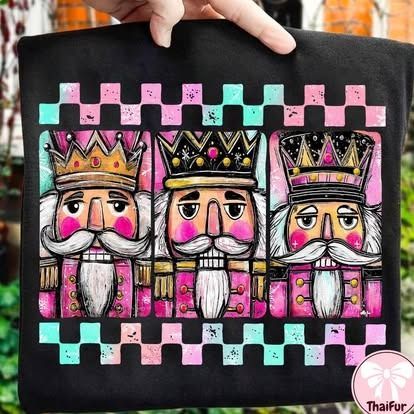 Black tote bag with colorful nutcracker illustrations.