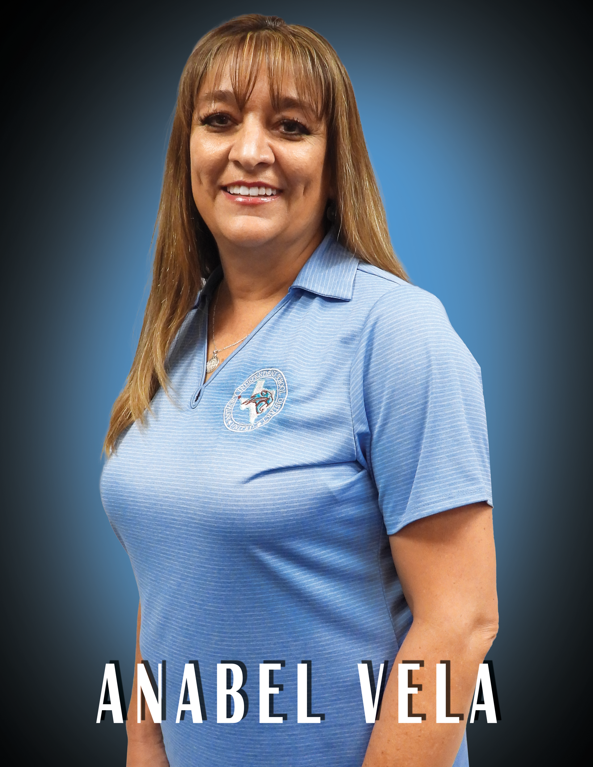 Trustee Anabel Vela wearing a blue shirt standing in front of a blue background.