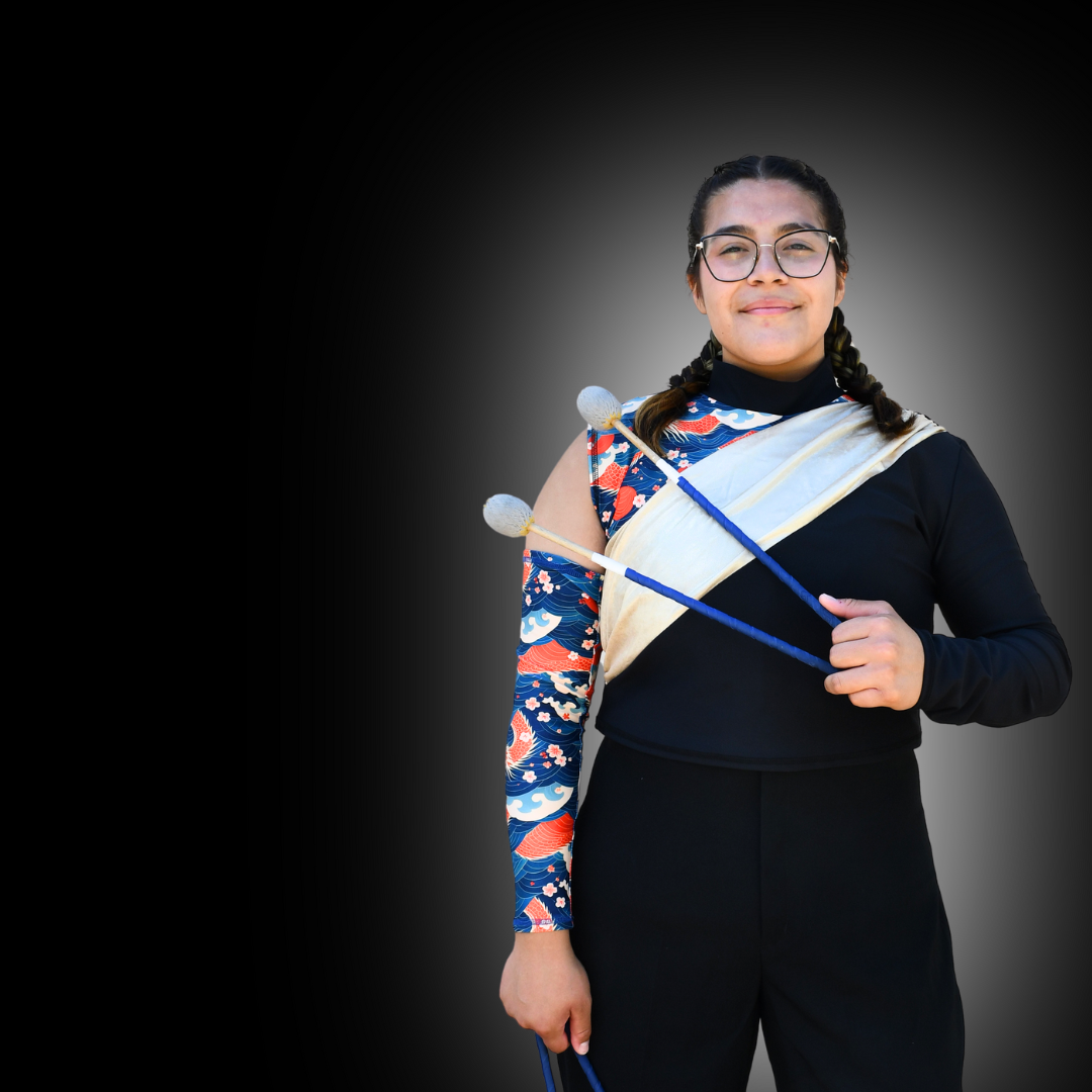 Band student holds instrument.