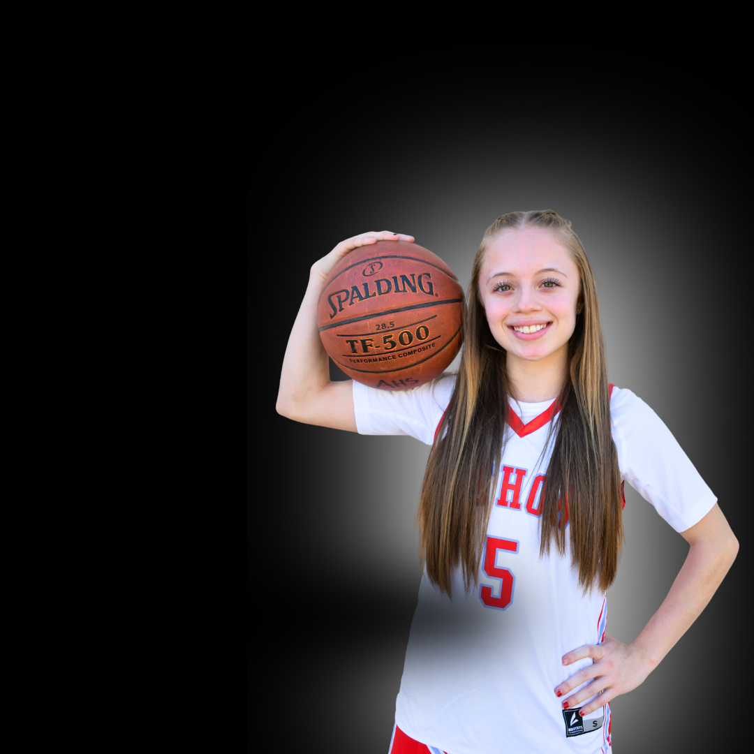 Girl holds basketball on her shoulder