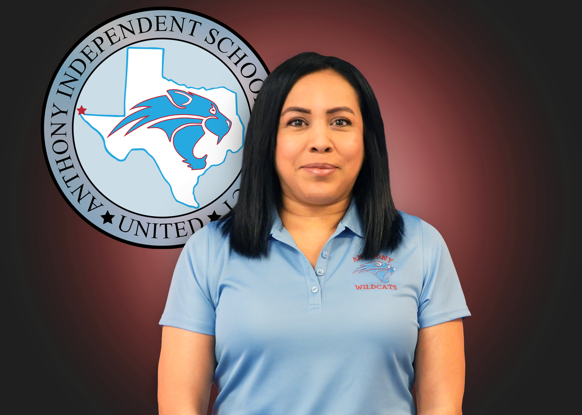 A woman in a blue shirt is standing in front of an anthony independent school logo.