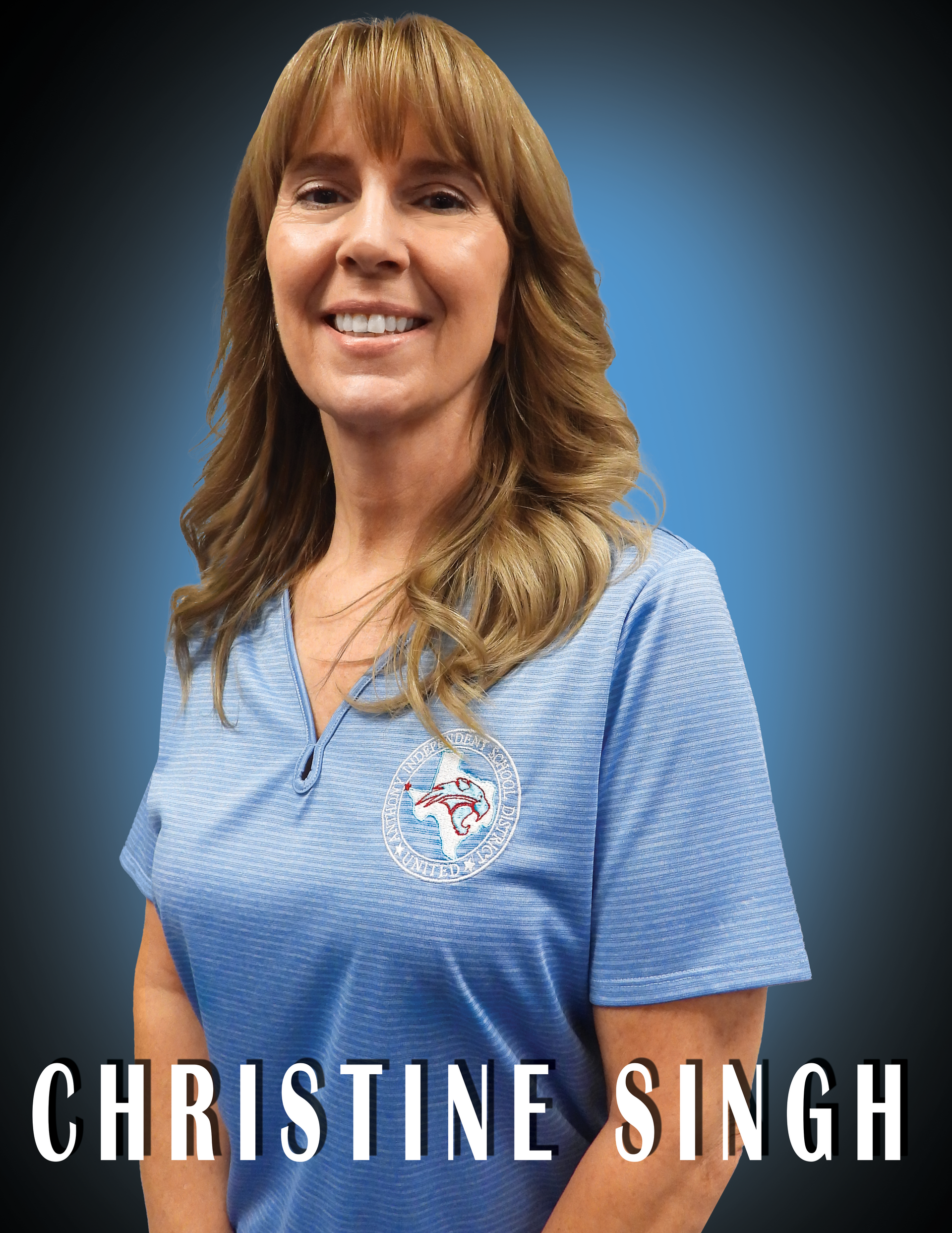 Trustee Christine Singh wearing a blue shirt standing in front of a blue background.