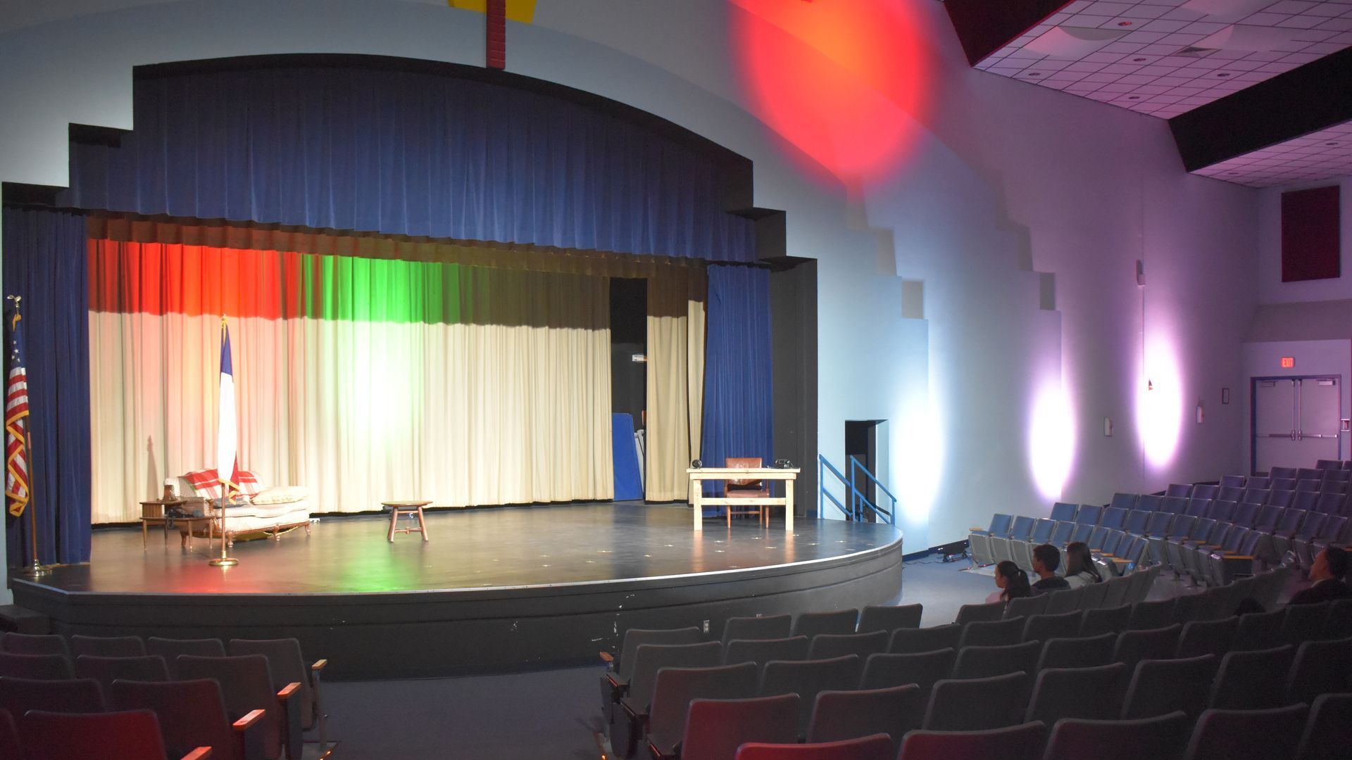 A large auditorium with a stage and rows of seats.