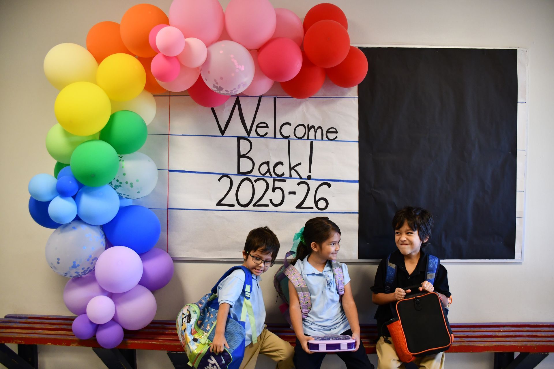 Anthony Elementary School students in front of Welcome Back sign with baloons