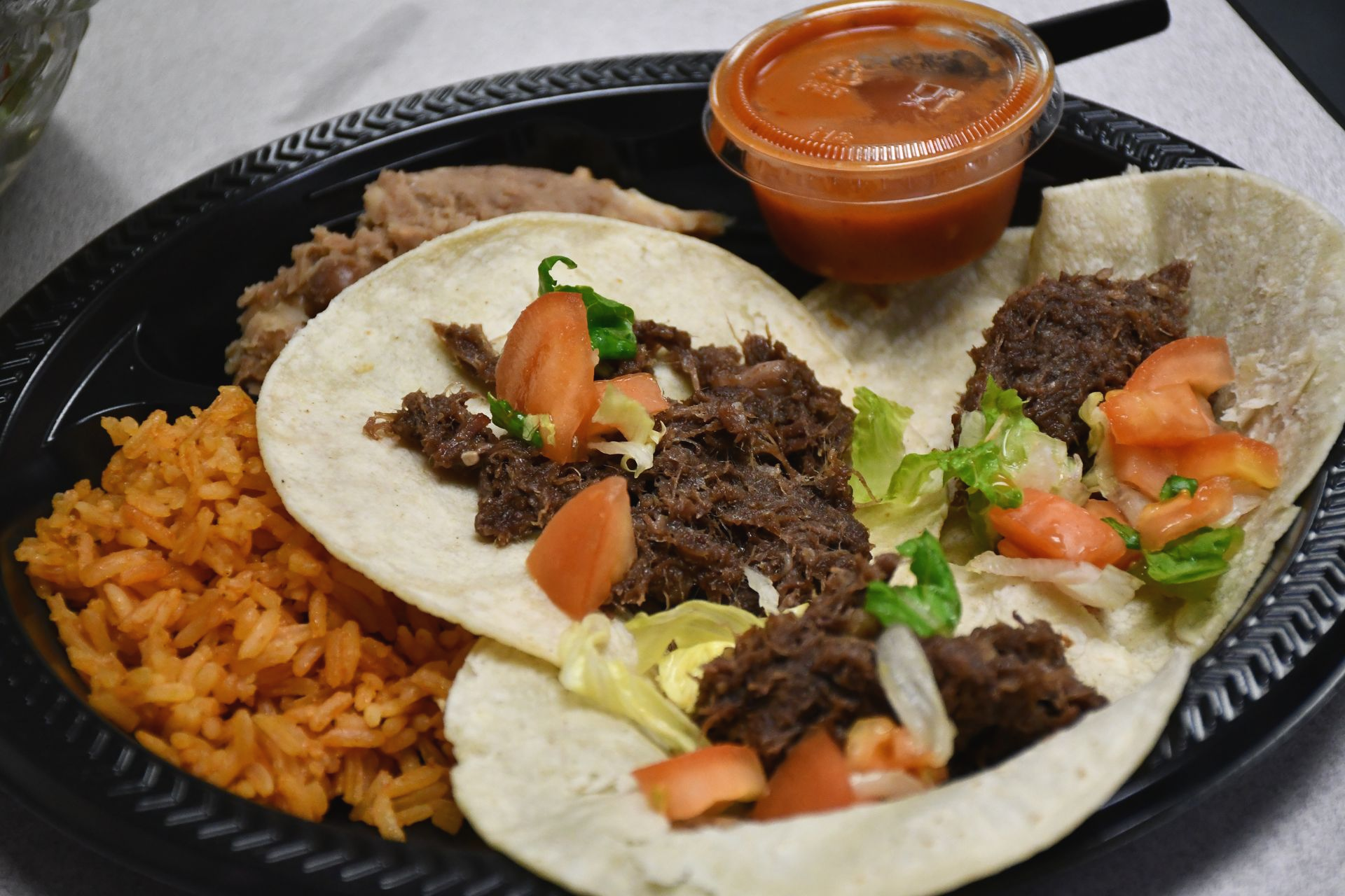 Tacos, rice, salsa, beans