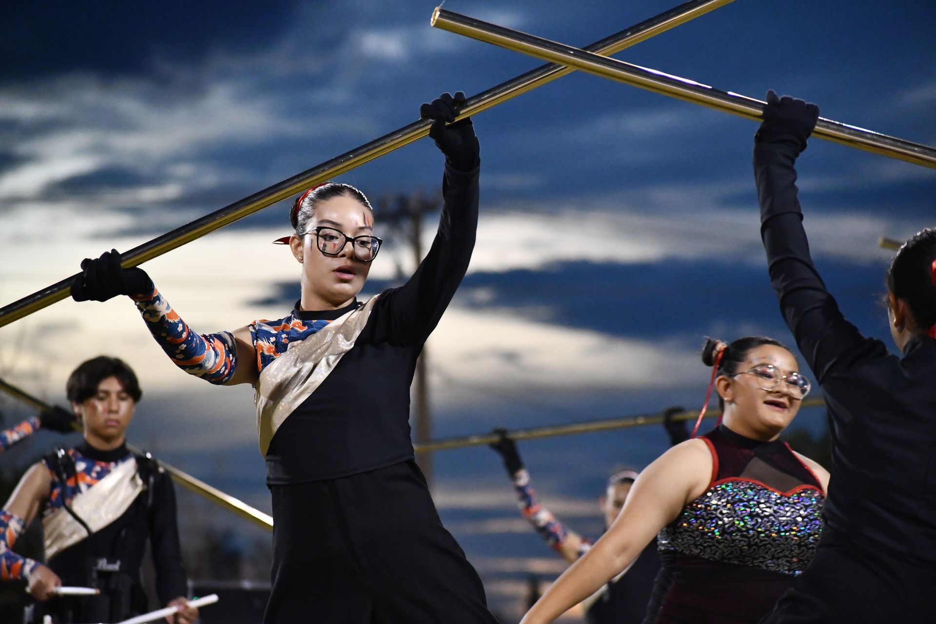 Student uses stick prop to perform during halftime show