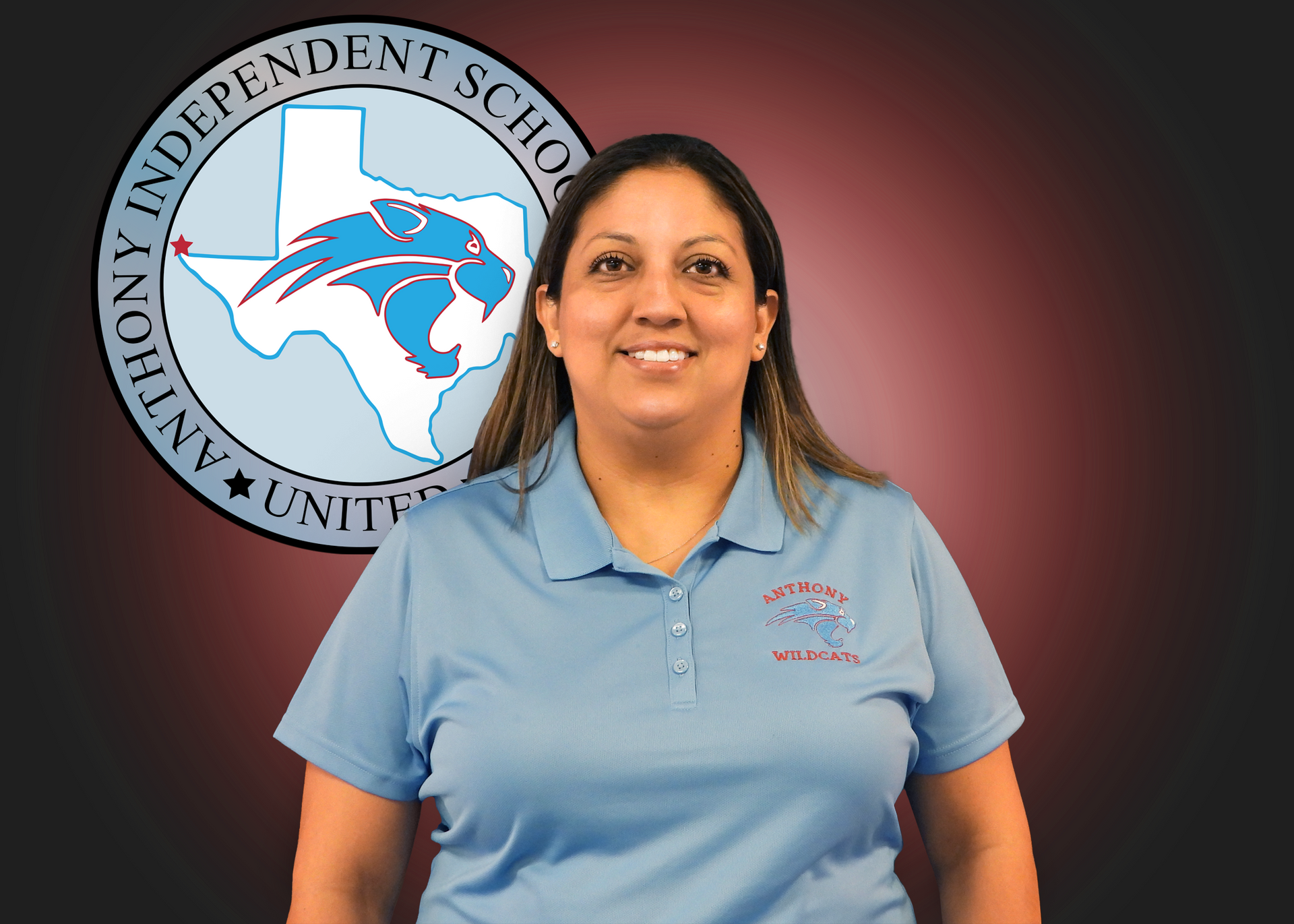 A woman in a blue polo shirt is standing in front of an anthony independent school logo.