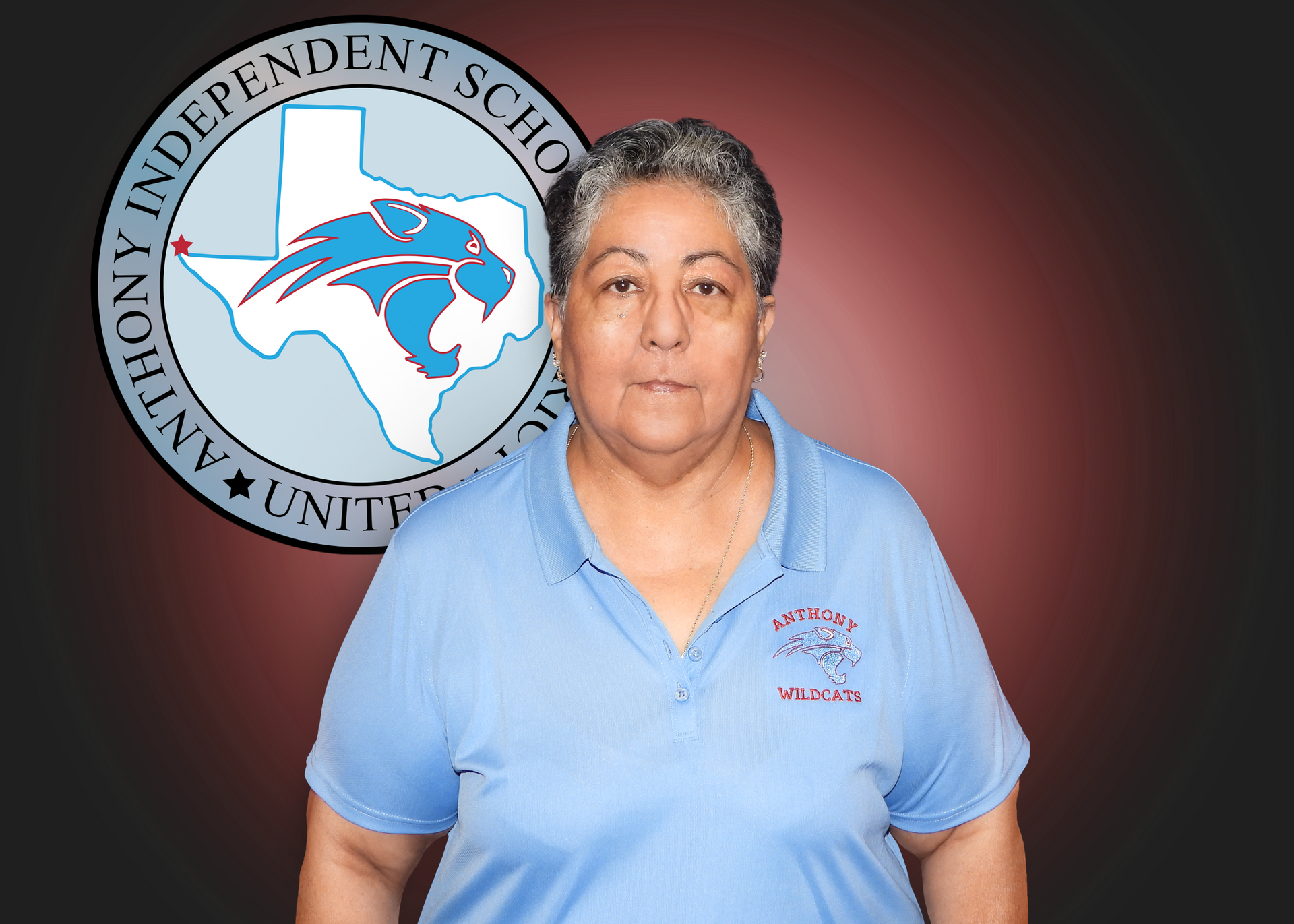 A woman in a blue shirt is standing in front of a logo for anthony independent school