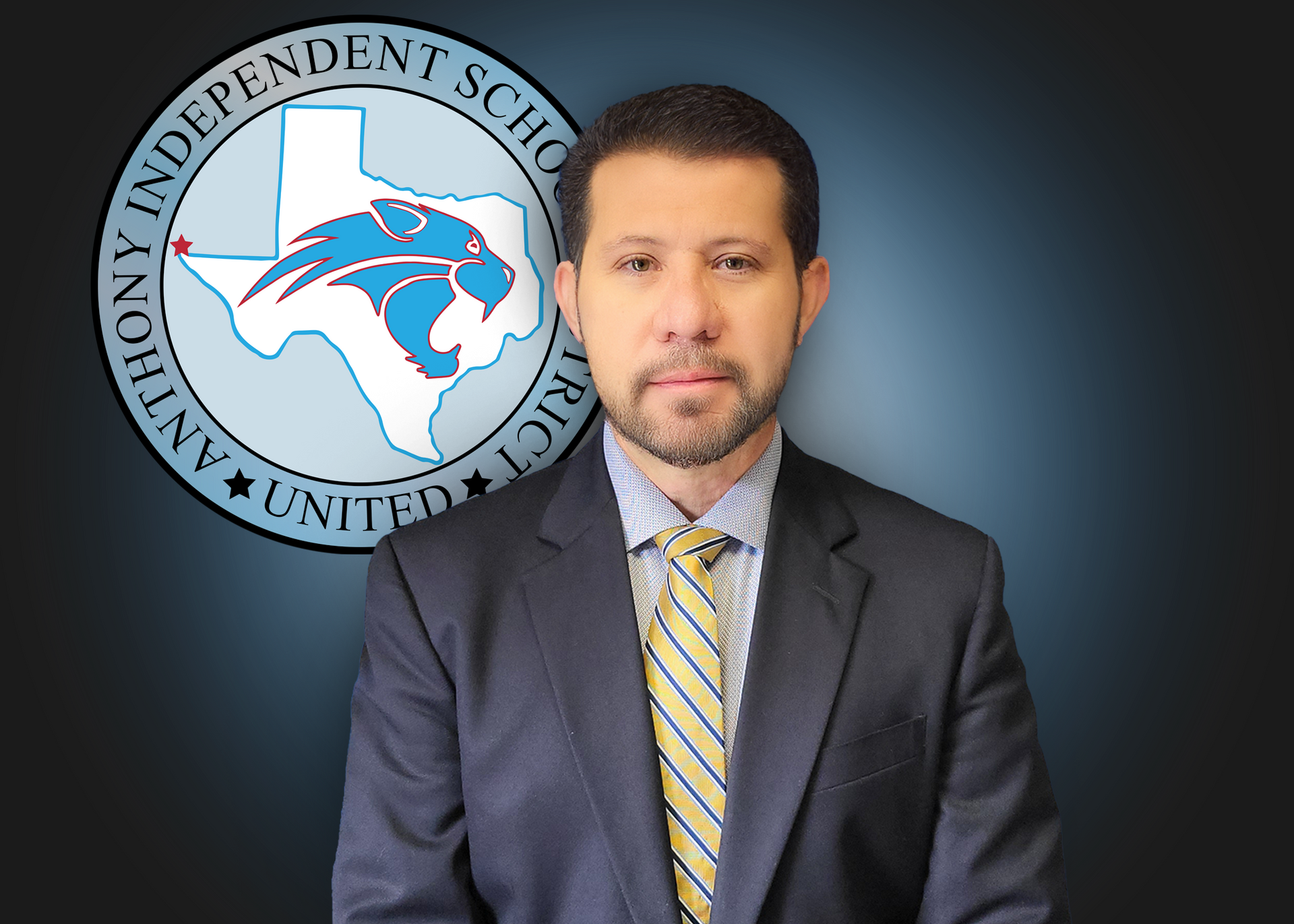 A man in a suit and tie stands in front of an independent school logo