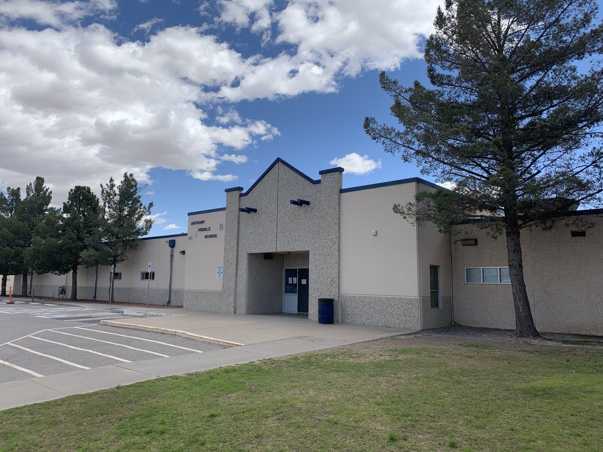 A large building with a parking lot in front of it