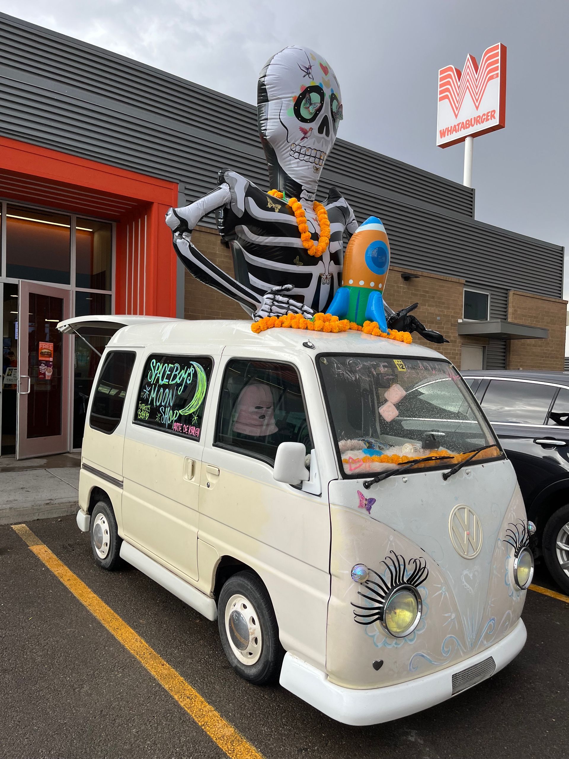 Buggy van decorated with eyelashes on the headlights and a skeleton inflatble arising from the top