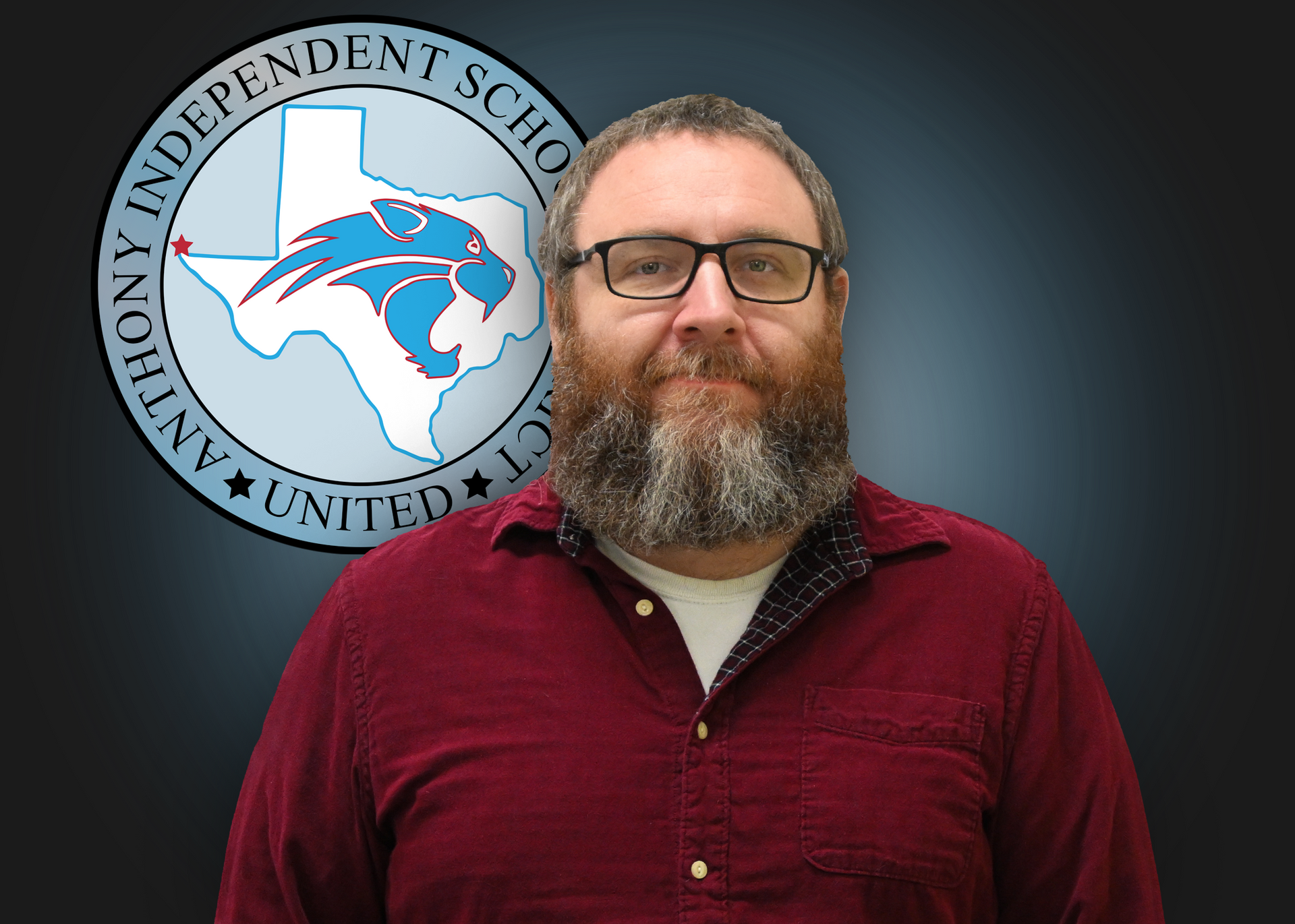 A man with a beard and glasses is standing in front of an independent school logo.