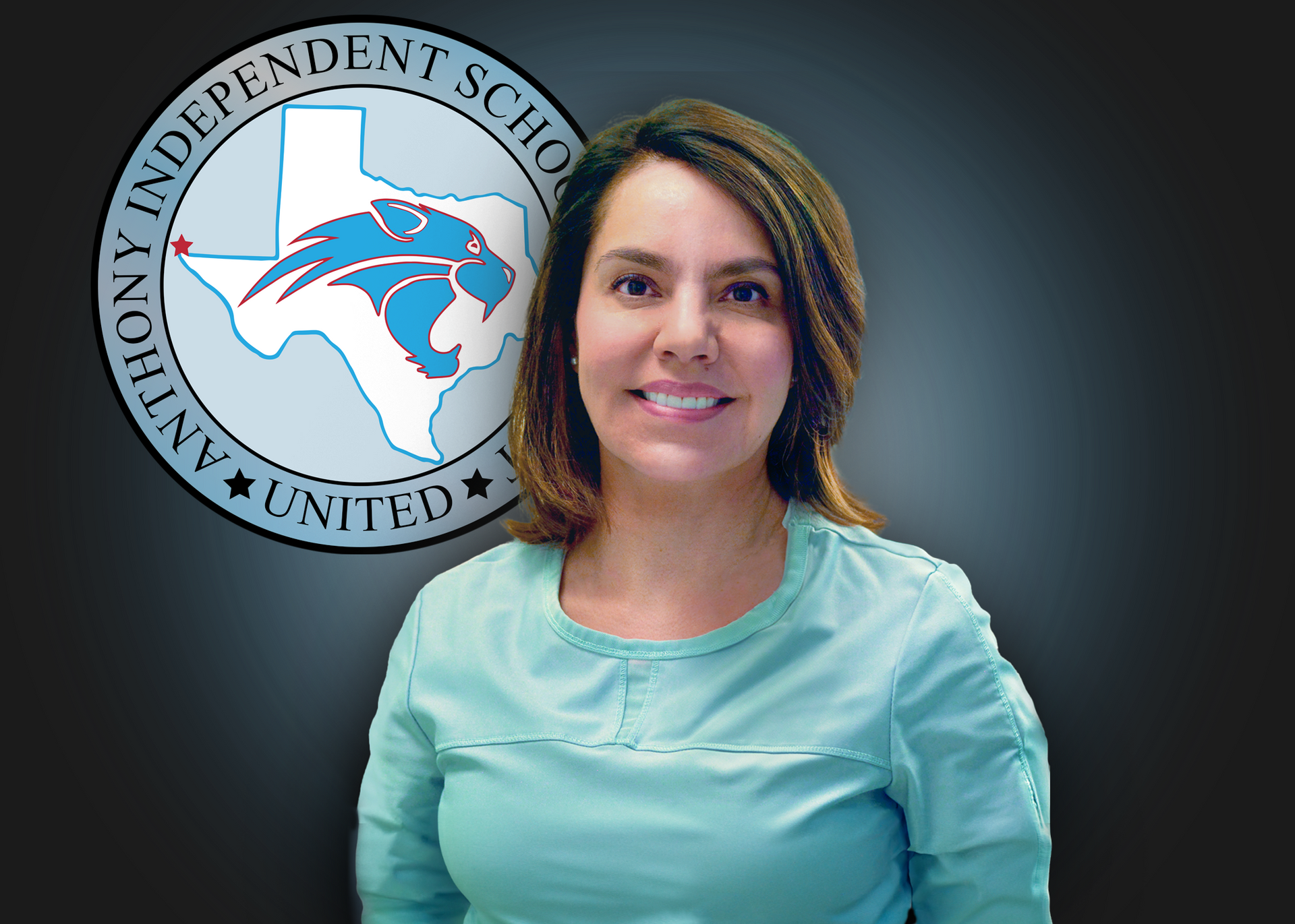 Woman wearing blue scrubs stands in front of Anthony ISD logo.