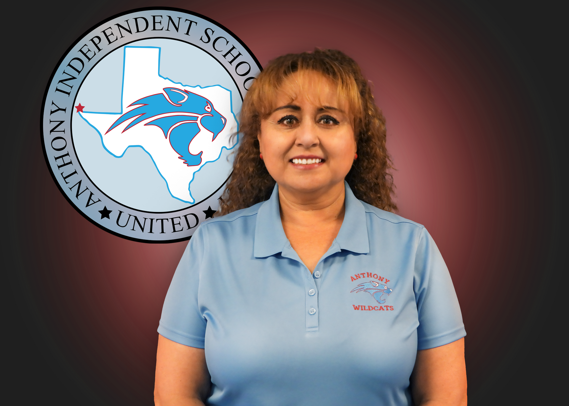A woman in a blue polo shirt is standing in front of an anthony independent school logo.