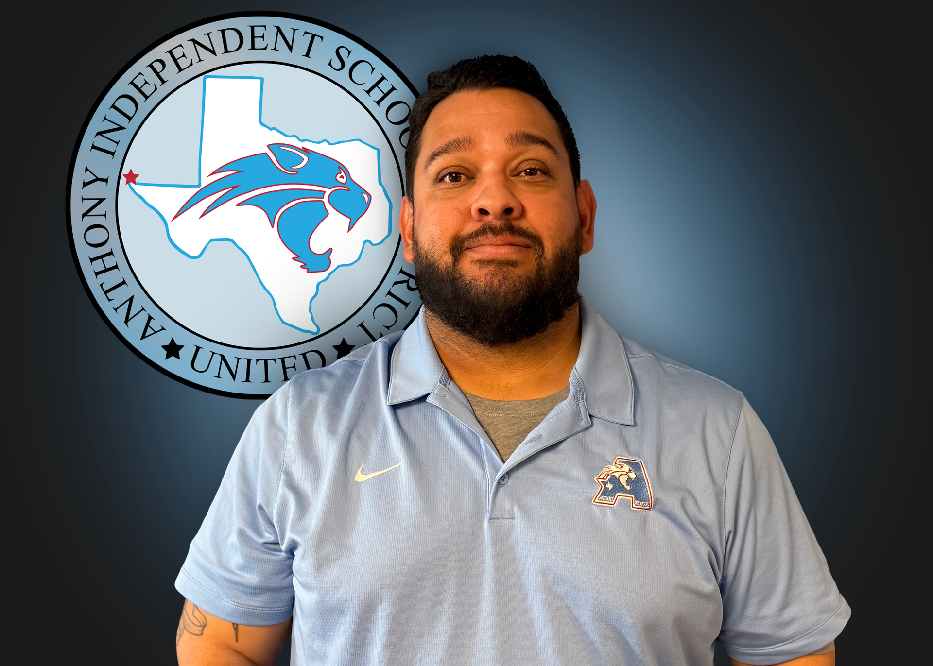 A man with a beard is standing in front of an independent school logo