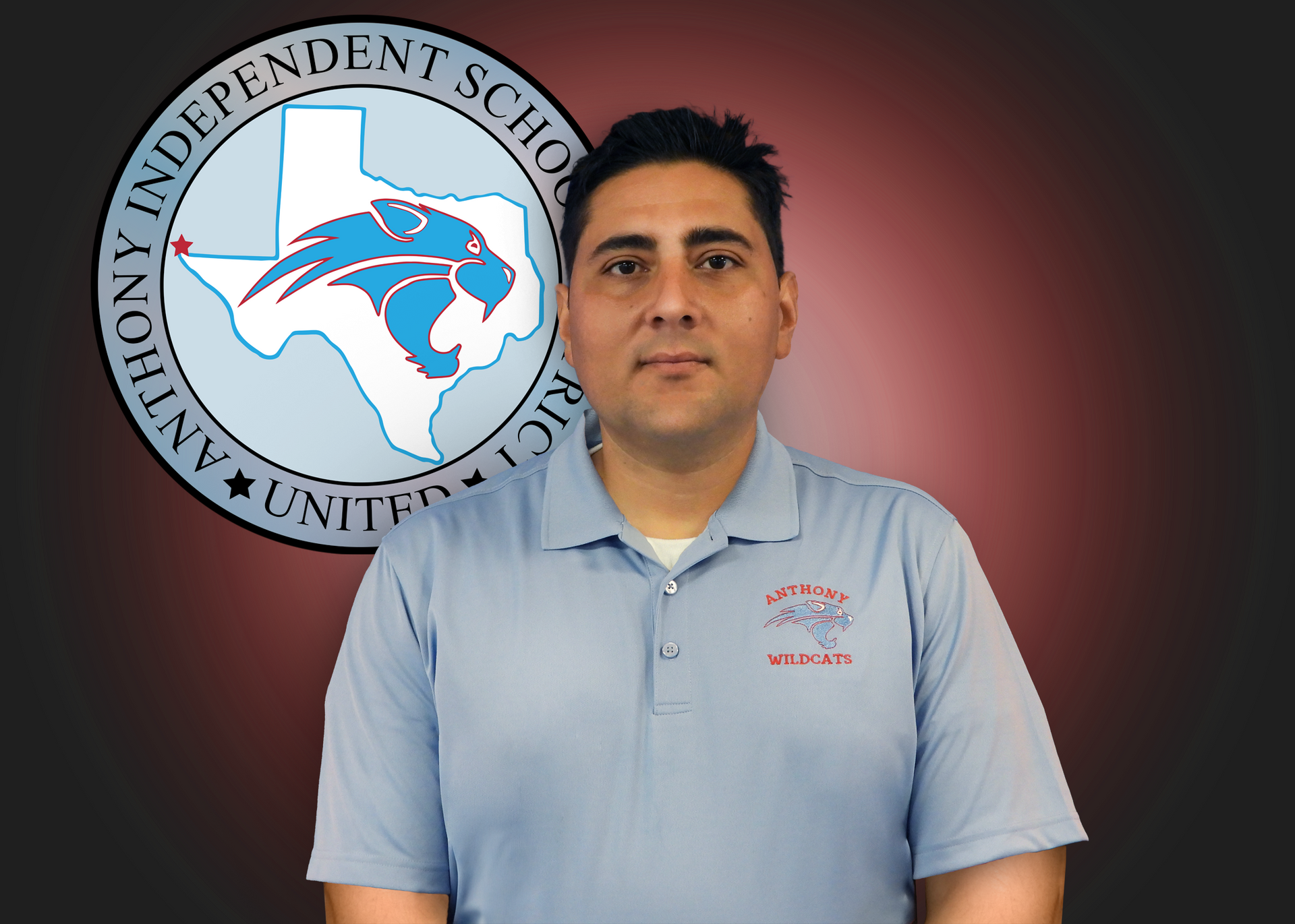 A man stands in front of an independent school logo