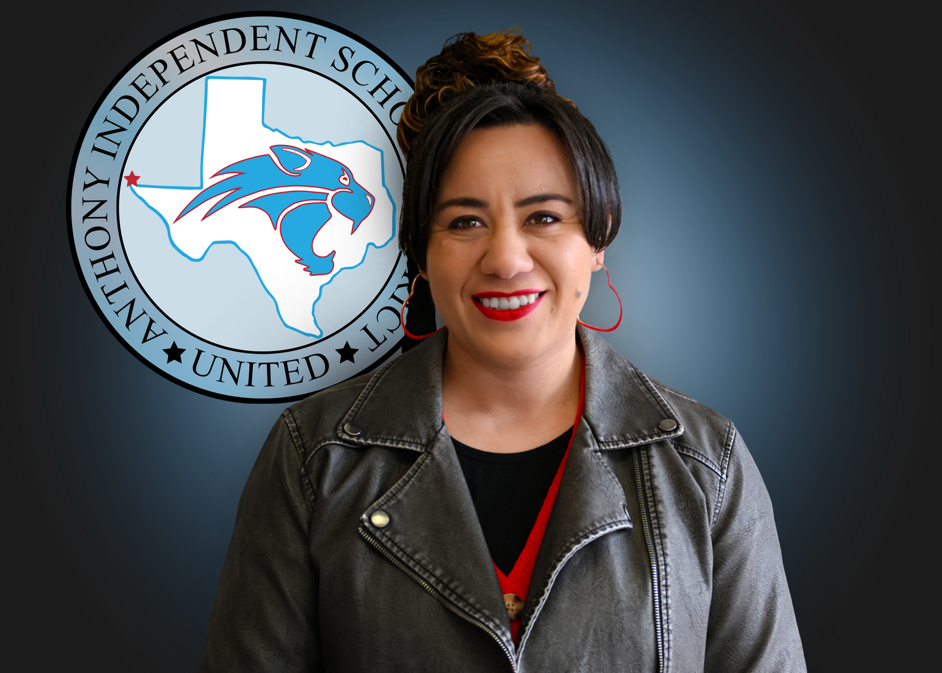 Woman stands in front of Anthony ISD logo.
